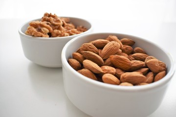 almonds and nuts in white round plates