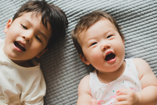 Happy siblings looking at camera