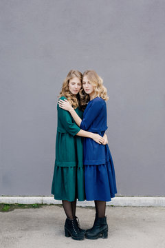 Two sisters twins hugging