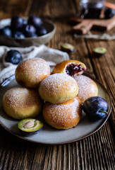 Traditional sweet baked buns filled with plum marmalade