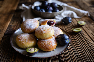 Traditional sweet baked buns filled with plum marmalade