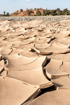 Dry river in front of an old adobe village. Morocco, Africa