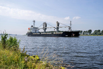 general cargo vessel shipping on canal