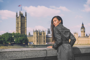 London trench coat business woman at Westminster. Fashion businesswoman in grey raincoat. Asian beauty model outdoor.