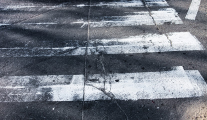 Old zebra crossing lines on the road