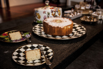 slice of cake with powder sugar on top on a dark wood background. selective focus