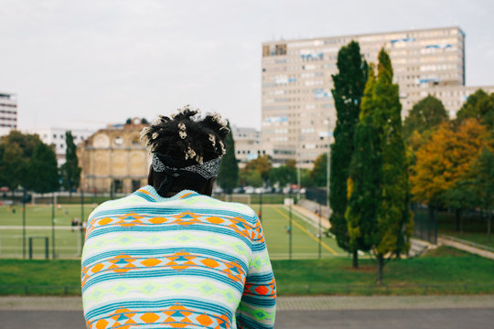 Colorfully-Dressed Dreadlocked Black Young Man From Behind