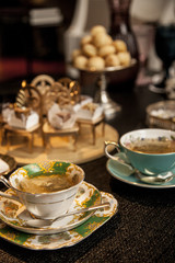 elegant tea cup on a dark wooden table.