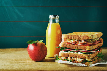 Lunch food set with sandwich, orange juice, apple