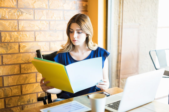 Freelancer Reviewing Some Reports At Coffee Shop