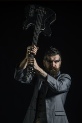 Fototapeta premium Music concept. Bearded man hold guitar in hands at music festival. Man with musical instrument, music hobby. Music makes me stronger