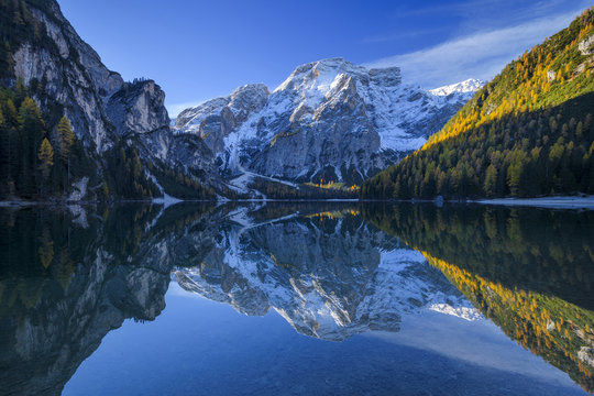 Croda del Becco (Seekofel) reflected in the calm waters of Braies Lake in autumn in the Prags Dolomites, South Tyrol, Italy