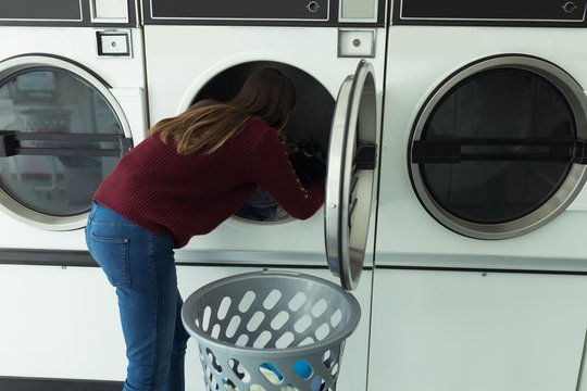 Woman Doing Laundry In Laundromat