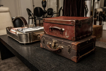 Vintage Pile Ancient Suitcases Form of Tower Design Concept Travel Luggage on a vintage living room