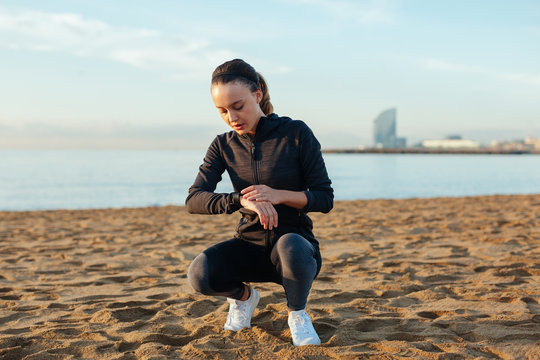Young woman doing sport on the beach on morning.