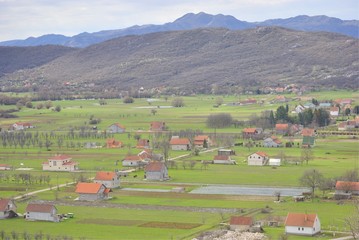 Rural landscape of Niksic, Montenegro. Village houses in the fields.