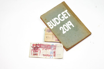 budget 2019 book and algeria dinar bill isolated on white background