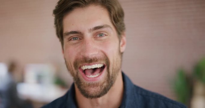 close up portrait of attractive young man laughing happy entrepreneur enjoying success slow motion