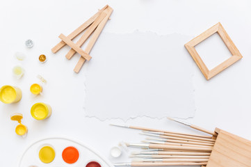 Top view Palette of watercolor paints, brushes on white background. Flat lay