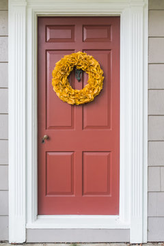 Bright yellow wreath made of flame tree leaves.