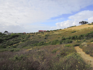 Fototapeta na wymiar Panorama of a mountainside with a path going to a house