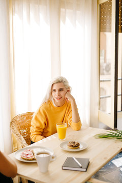 Woman conversating?during breakfast