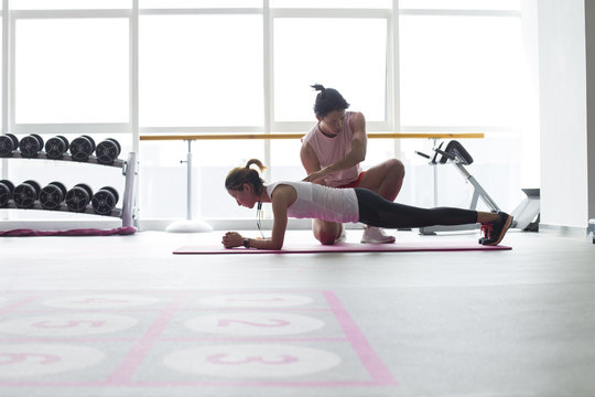 Young Asian Woman Work Out In The Gym With Her Coach