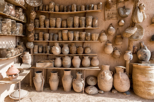Metalic teapots stacked on black stand in a moroccan souk