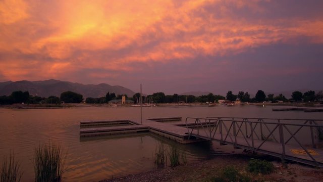 View of colorful sunset glowing over boat dock in Provo Boat Harbor as the wind blows.