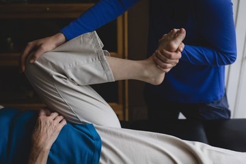 Physiotherapist assisting a senior woman with physiotherapy