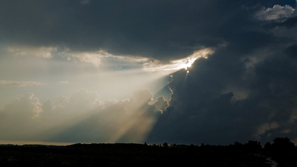 The rays of the sun break through the sky