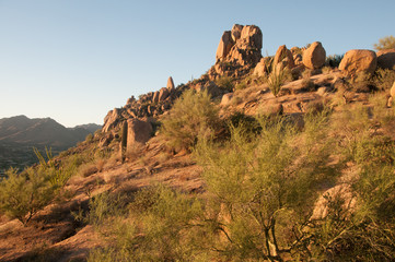 The sun warms boulders of Pinnacle Peak at dawn in the Mountains of Scottsdale, Arizona.