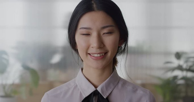 portrait young asian business woman intern smiling friendly enjoying professional career beautiful ethnic female in office slow motion