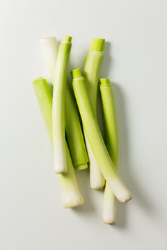 Trimmed leeks on white from overhead