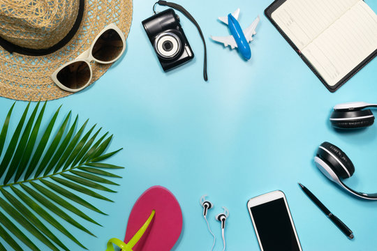 Top view, flat lay object accessories of travel or summer vacation concept with blank space on blue background.