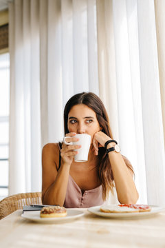 Woman drinking from cup in morning