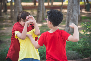 Naklejka premium Young asian boy bullied by two boys in park