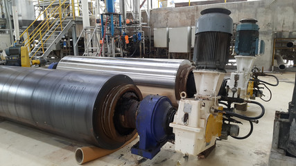 electrical parts and Mechanical parts on Big gear and drum rolls on white floor