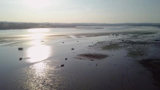 Sunset flyover of sail boats.