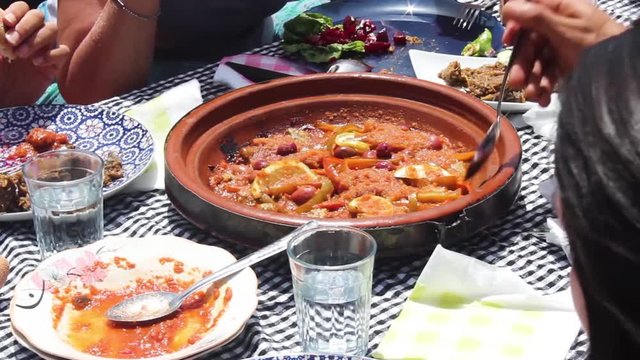 Friends Sharing a Tagine in a Sunny Day in Morocco
