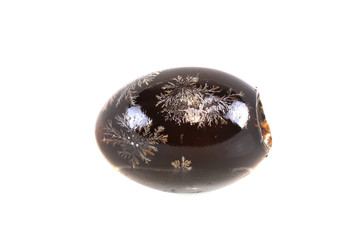 close up on single preserved egg isolated on white background