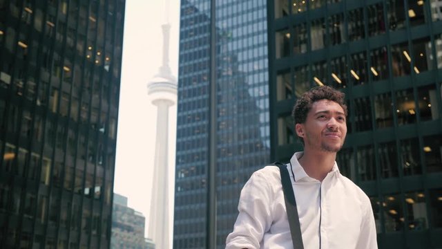 Confident Recent Graduate Stands Between Office Buildings in Courtyard, Confidently Looking Ahead to Future, Financial District of Toronto, Slow Motion 4K 60FPS