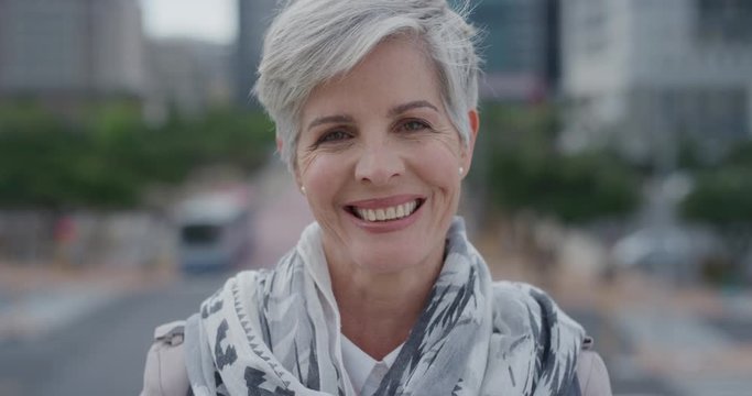 portrait beautiful middle aged caucasian woman smiling enjoying successful urban lifestyle in city 