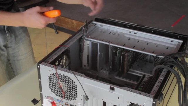 Unscrewing screws while building a computer.