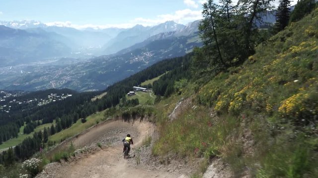 Person Jumping on Mountain trail with downhill bike