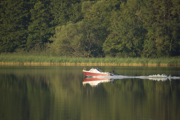 Fototapeta na wymiar Small motor boat at a tranquil lake Mälaren in Stockholm