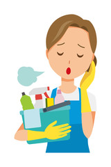 A woman wearing a blue apron and rubber gloves sighs while holding some cleaning tools