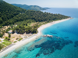 Early sunrise and snorkelling at the private Kastani beach on the island of Skopelos in Greece. Aqua waters and coral - obrazy, fototapety, plakaty