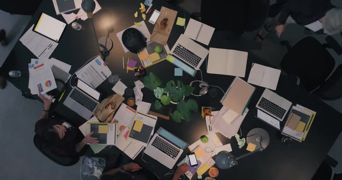 happy business woman celebrating success sharing successful idea with colleagues in multi ethnic office executive team in messy boardroom top view