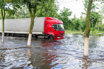 Big truck going through flooded street in town Gomel in Belarus